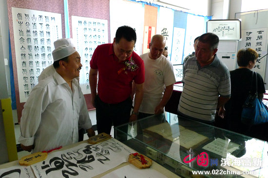 天穆村党委书记穆祥友与阿文书法作者一起交流。
